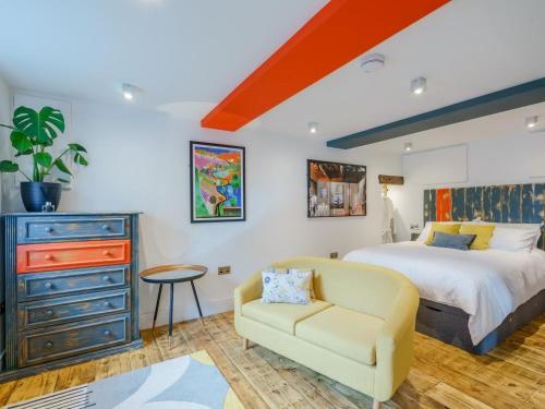 a bedroom with a bed and a chair and a dresser at 1 Bed in Skipton oc-78576 in Skipton