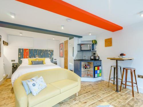 a bedroom with a bed and a couch in a room at 1 Bed in Skipton oc-78576 in Skipton