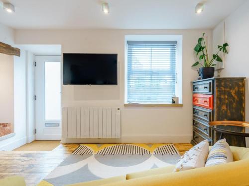 a living room with a couch and a flat screen tv at 1 Bed in Skipton oc-78576 in Skipton