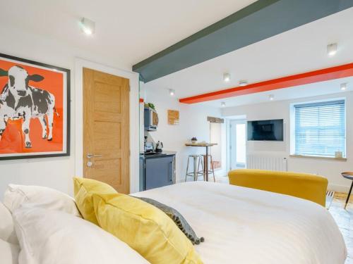 a bedroom with a bed with a cow painting on the wall at 1 Bed in Skipton oc-78576 in Skipton