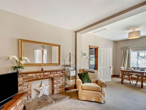 a living room with a fireplace and a mirror at 1 Bed in York oc-84002 in Crayke