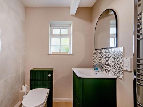 a bathroom with a green vanity and a mirror at 1 Bed in York oc-84002 in Crayke