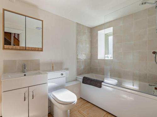 a bathroom with a toilet and a tub and a sink at 3 Bed in Montacute oc-92227 in Montacute