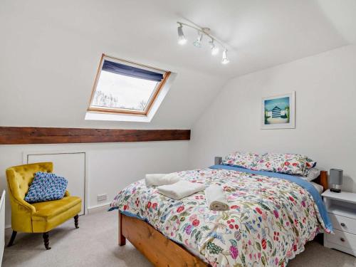 a bedroom with a bed and a yellow chair at 3 Bed in Ripon oc-94477 in Ripon