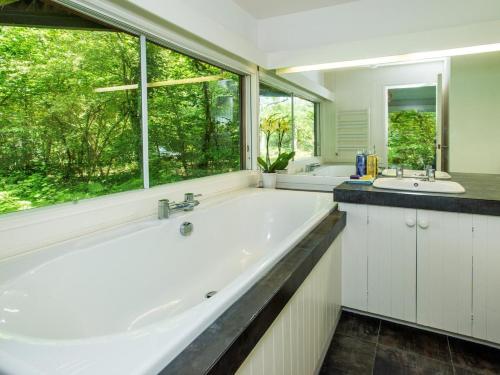 a bathroom with a large tub and a large window at 2 Bed in Beaulieu oc-nfl71 in Beaulieu