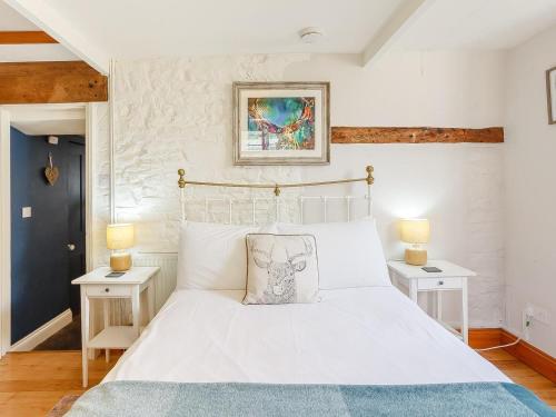 a bedroom with a white bed with two night stands at 1 Bed in Wedmore oc-51341 in Chapel Allerton