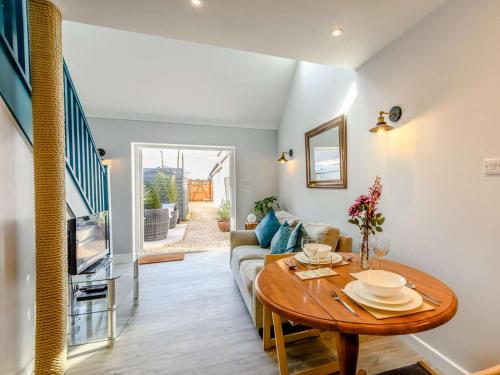 a living room with a table and a couch at 1 Bed in Lymington oc-81429 in Lymington