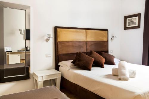 a bedroom with a bed with a large headboard at LaHouse Rome by Premium Suites Collection in Rome