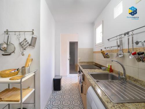 a kitchen with a sink and a counter at Can Tassi in Porto Cristo