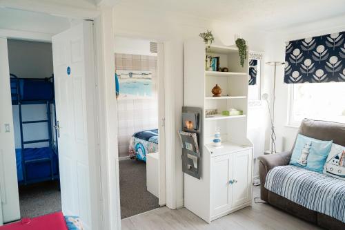 a small bedroom with a bed and a couch at Chalet 80 in Sandown