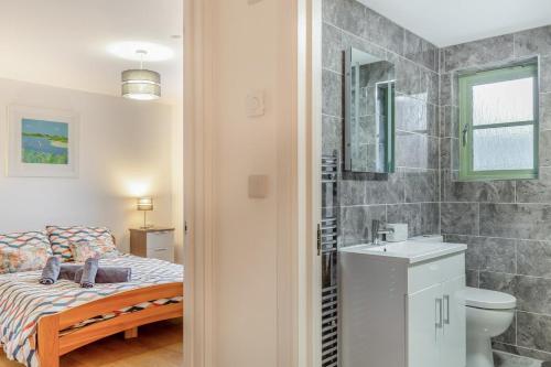 a bathroom with a bed and a toilet and a sink at 3 Bed in Winnards Perch oc-m30557 in Saint Columb Major