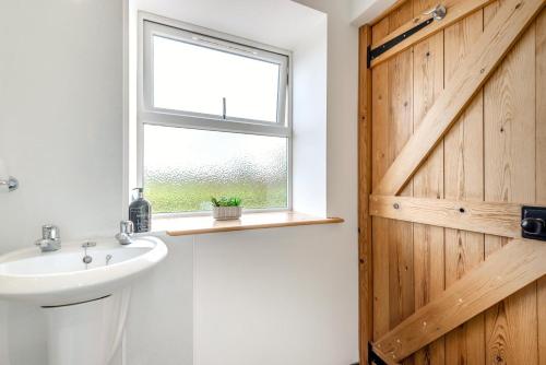 a bathroom with a sink and a window at 3 Bed in Scaleby oc-b33069 in Scaleby