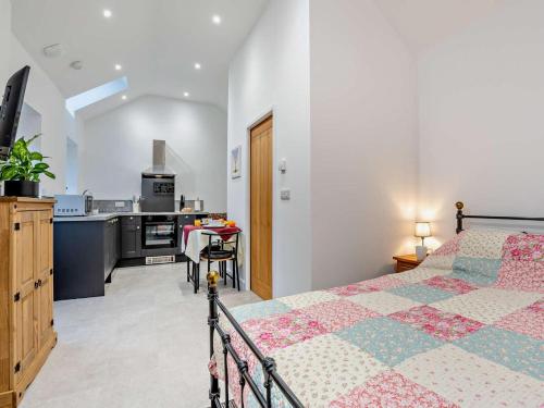 a bedroom with a bed and a kitchen at 1 Bed in Pickering oc-96309 in Allerston
