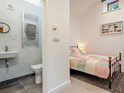 a bathroom with a bed and a sink and a toilet at 1 Bed in Pickering oc-96309 in Allerston