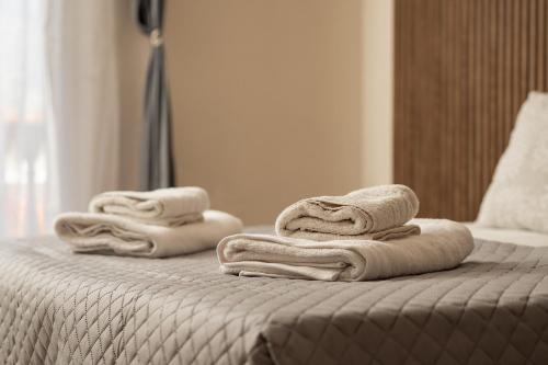 two towels on a bed in a hotel room at Aggire Summer Suites in Alikanas