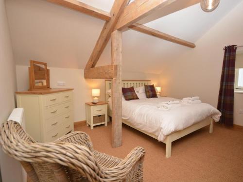 a bedroom with a bed and two chairs in it at 3 Bed in Bristol oc-58129 in Burrington