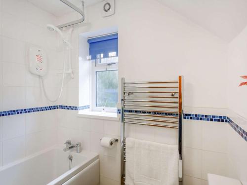 a white bathroom with a tub and a shower at 2 Bed in Skipton oc-87598 in Kettlewell