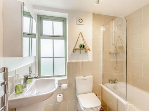 a bathroom with a toilet and a sink and a tub at 3 Bed in Keighley oc-89528 in Haworth