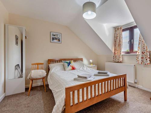 a bedroom with a bed and a chair in it at 4 Bed in Wareham oc-77511 in Stoborough