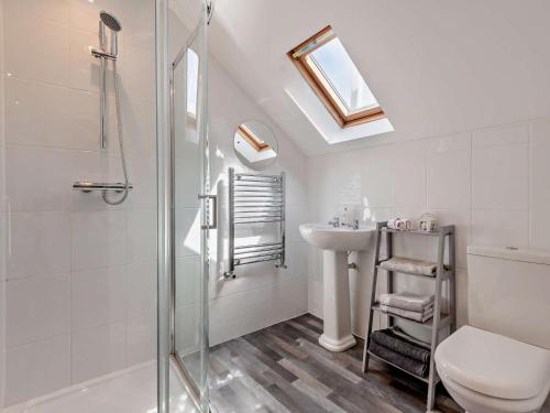a bathroom with a shower and a toilet and a sink at 4 Bed in Wareham oc-77511 in Stoborough