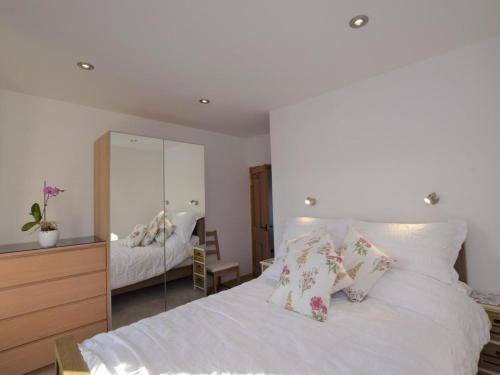 a bedroom with a white bed with pillows and a mirror at 1 Bed in Taunton oc-49569 in North Curry