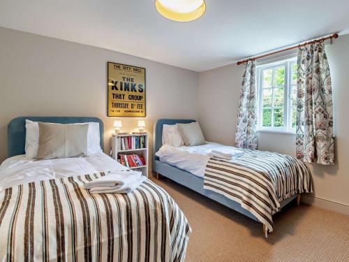 a bedroom with two beds and a window at 3 Bed in Salisbury oc-95325 in Amesbury