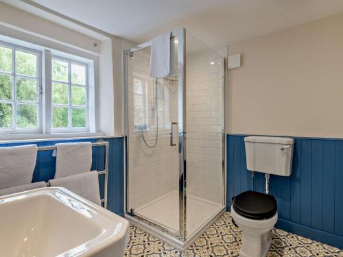 a bathroom with a shower and a toilet and a tub at 3 Bed in Salisbury oc-95325 in Amesbury