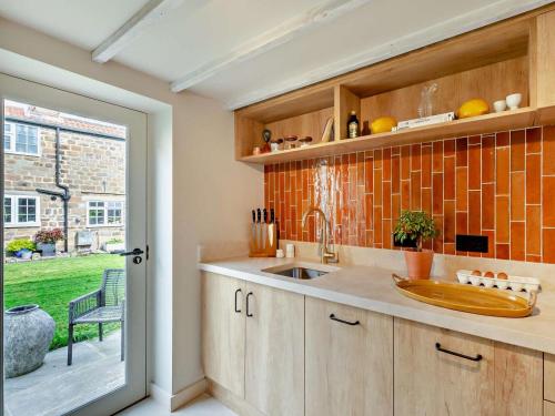 a kitchen with a sink and an open door at 2 Bed in Knaresborough oc-95078 in Brompton