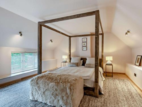 a bedroom with a canopy bed and a large window at 2 Bed in Knaresborough oc-95078 in Brompton
