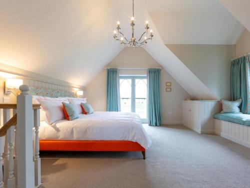 a bedroom with a large bed with a chandelier at 1 Bed in Ripon oc-95074 in Dishforth