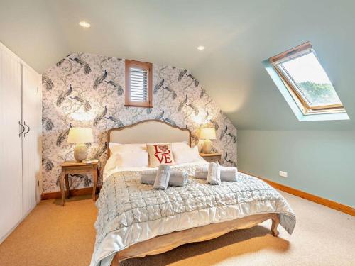 a bedroom with a large bed with a stone wall at 1 Bed in Southampton oc-92943 in Chalbury
