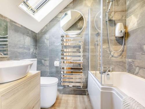 a bathroom with a sink and a tub and a mirror at 2 Bed in Taunton oc-88884 in Isle Brewers