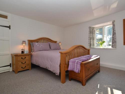 a bedroom with a bed and a table and a window at 2 Bed in Dorchester oc-66192 in Stratton