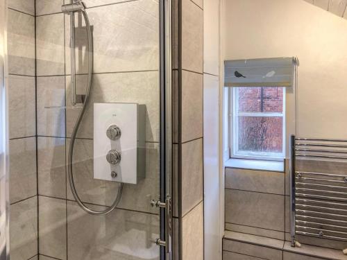 a shower with a glass door in a bathroom at 2 Bed in Malton oc-78794 in Norton