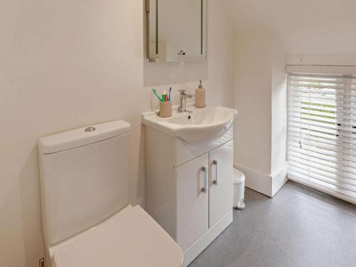 a white bathroom with a toilet and a sink at 1 Bed in Bristol oc-95178 in Blagdon