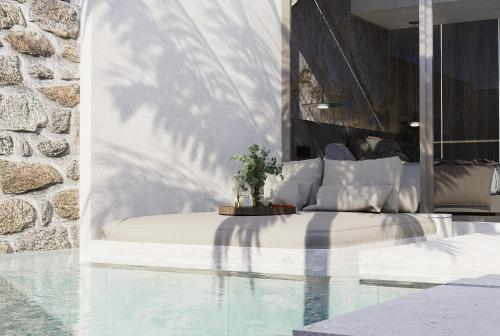 a bedroom with a bed next to a pool at Theretra Pefki Center in Pefki