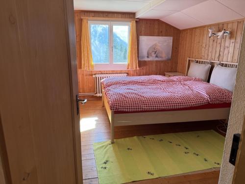 a small bedroom with a bed and a window at Revier Schwettiberg Nr. 1 in Braunwald