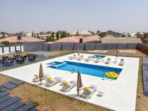 an overhead view of a pool with chairs and umbrellas at Peregrine Hotel Jos in Jos