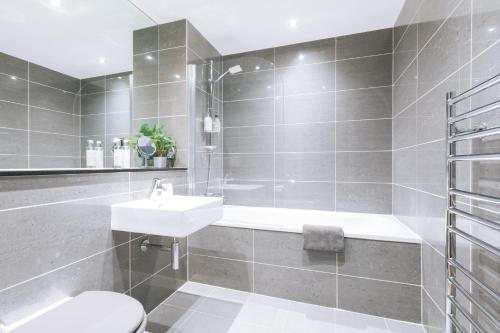 a bathroom with a sink and a toilet at Contemporary 1BD Flat - Bristol City Centre! in Bristol
