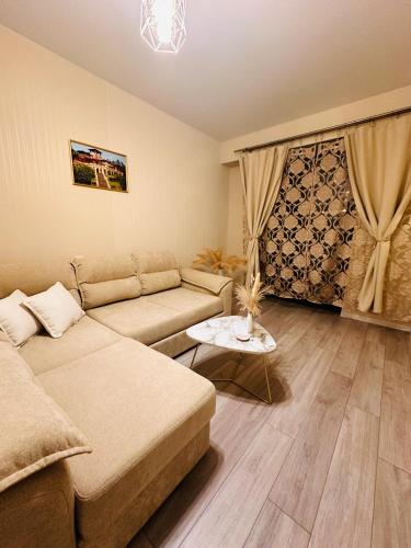 a living room with a couch and a table at Luxury Residence Likani in Borjomi