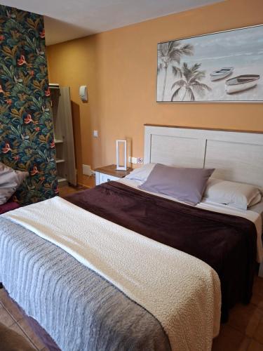 a bedroom with a large bed in a room at Wonderland Villa Tierra Fértil Los Gigantes in Santiago del Teide
