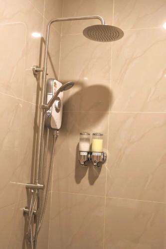 a shower with two candles in a bathroom at KL Dawarika Mali Hotel in Ban Tai