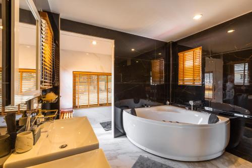 a large bathroom with a tub and a sink at Villa Natali between Rawai and Nai Harn in Rawai Beach