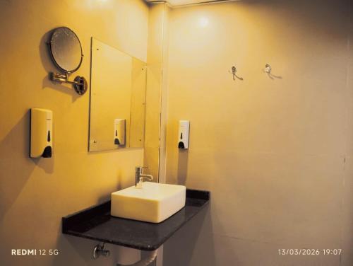 a bathroom with a sink and a mirror at hotel Gautam Inn in Gorakhpur