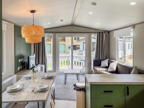 a dining room with a table and a living room at Beamish Holiday Park in Stanley