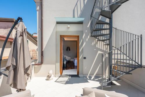 a staircase leading up to a house with a patio at Torre Saracena Massa Lubrense in Massa Lubrense