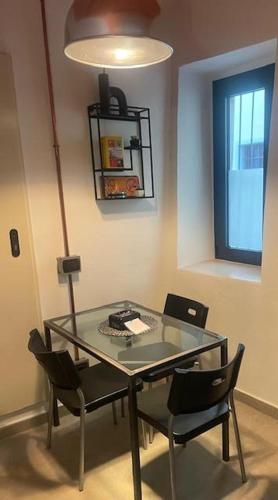 a glass table and chairs in a room with a window at Antico Glicine in Ispra