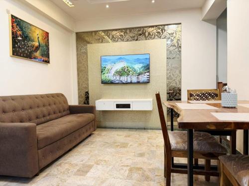 a living room with a couch and a table at Divine Abode in Thane