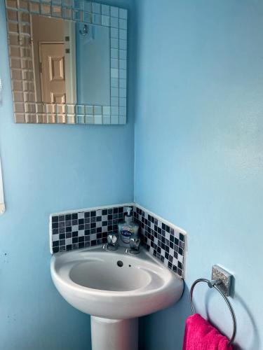 a bathroom with a sink and a mirror at Ailsa Seaview in Turnberry