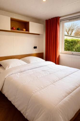 a large white bed in a room with a window at Eden Cottages - Premium Cottage avec Piscine in Antibes